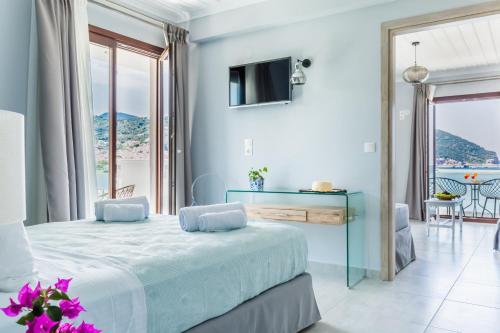 a bedroom with a bed with a view of the ocean at Olia Green Residence in Skopelos Town