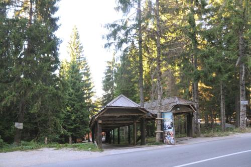 a wooden pavilion on the side of a road at Vila Jelena Zlatar Nova varoš in Brdo
