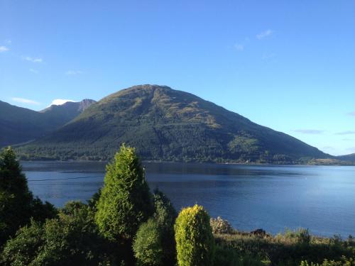a mountain in the middle of a body of water at The Lodge On The Loch Onich in Onich