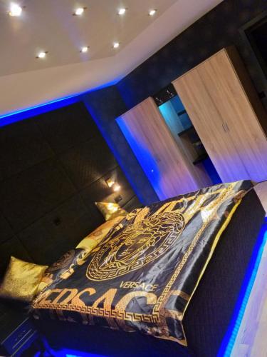 a large bed in a room with blue lights at modern Hoteliving Gießen in Gießen