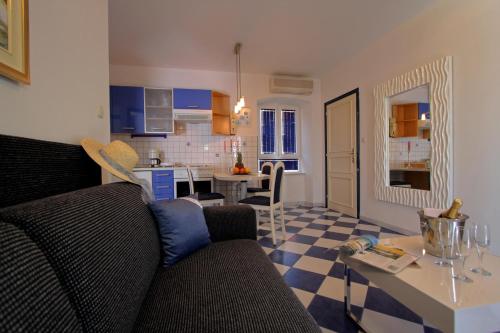 a living room and kitchen with a couch and a table at Apartments AMORE in Bol