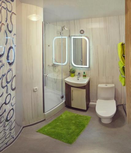 a bathroom with a toilet and a sink and a shower at Luxury 2 Rooms Apartments in Center by Green House in Poltava