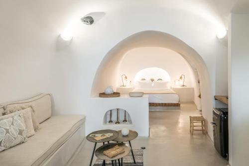 a living room with a couch and a bed at Cocoon Suites in Imerovigli