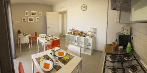a small kitchen with a table and a dining room at Villa Ulivi B&B in Pontecagnano