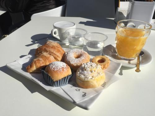 a plate of pastries on a table with a drink at B&B di mare e d'azzurro in Salerno
