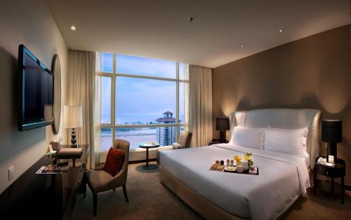 a hotel room with a bed and a large window at Hatten Hotel Melaka in Melaka