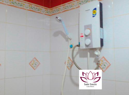 a shower in a bathroom with a sign on the wall at พูลวิลล่า เชียงใหม่ in Doi Saket