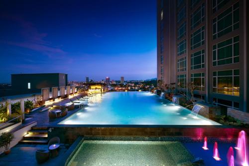 a swimming pool on top of a building at night at Hatten Hotel Melaka in Melaka