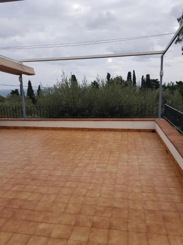 a patio with a wooden floor and a fence at Hostal Ondina in Begur