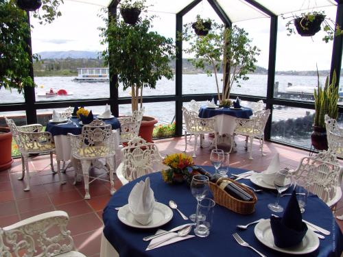a dining room with a view of the water at Puertolago Country Inn & Resort in Otavalo