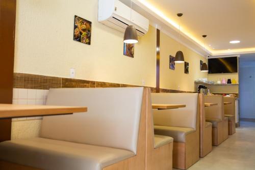 a restaurant with a row of chairs and tables at Pousada Nascer do Sol in Arraial do Cabo