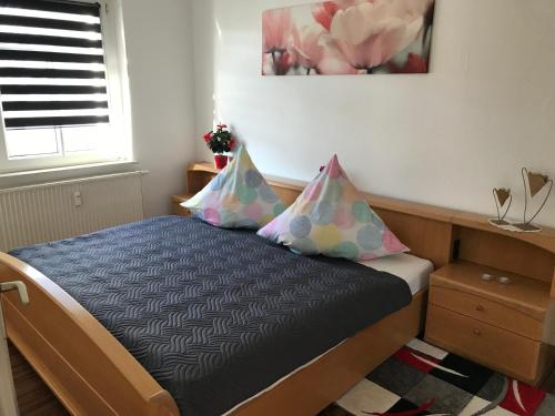 a bedroom with a bed with two pillows on it at Apartment Juna in Auerbach