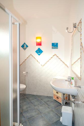 a bathroom with a sink and a toilet at Casa Vacanze Diaz in Budoni