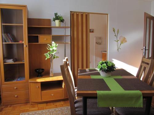 a dining room with a table and a cabinet at Privat Ľubka in Zuberec