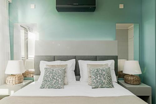 a bedroom with a white bed with two lamps at Vila Formosa I by An Island Apart in Funchal