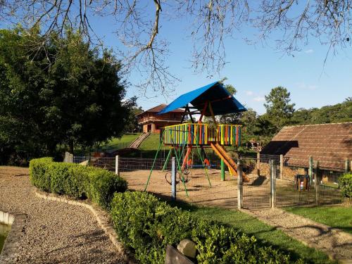 a playground with a play equipment in a park at Pousada Scursel in Ibirama