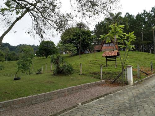 a park with a house on a hill at Pousada Scursel in Ibirama