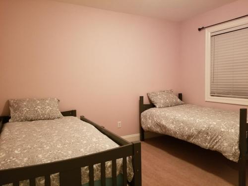 a bedroom with two beds and a window at JOFER Seattle/Renton Home in Renton