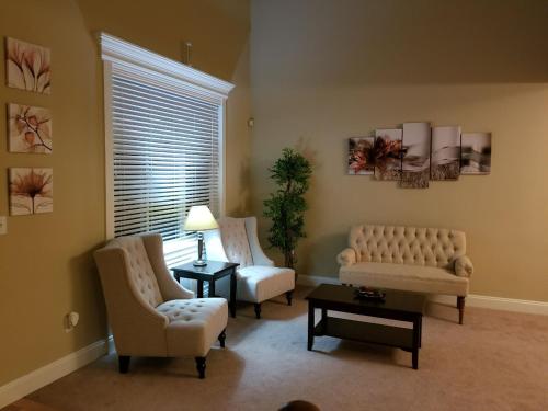 a living room with two chairs and a table at JOFER Seattle/Renton Home in Renton