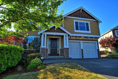 a brown house with a garage at JOFER Seattle/Renton Home in Renton