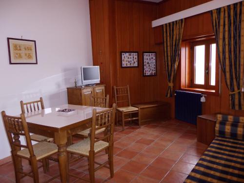 a dining room with a table and chairs and a television at Casa Dell'Orso in Roccaraso