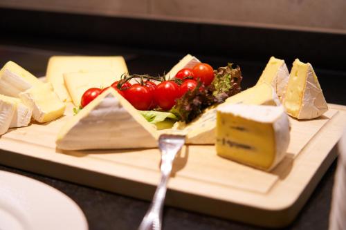 a plate of cheese and vegetables on a table at Landhotel Wilder Mann in Eggingen