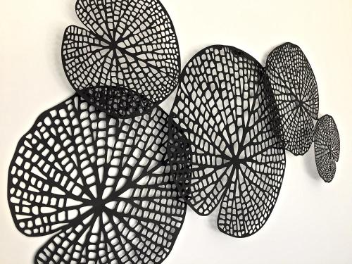 a black and white patterned plant on a wall at Ferienwohnung Black White in Raubling