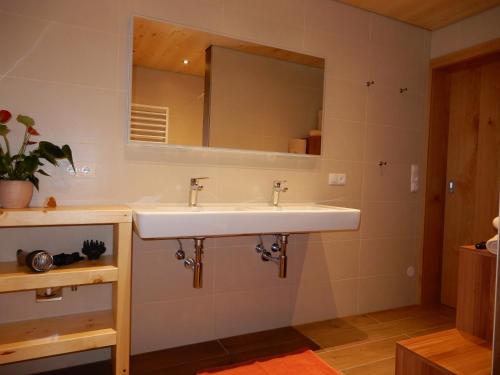 a bathroom with a sink and a mirror at Mottnerhof in Braz