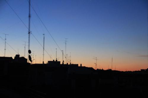a silhouette of a city with the sunset in the background at Apartments Plaza Mayor, Madrid Center in Madrid