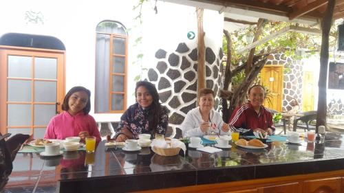 a group of people sitting at a table eating food at Hotel Coloma Galapagos in Puerto Ayora
