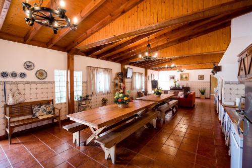 a large living room with a large wooden table at Vale do Grou Natura in Óbidos