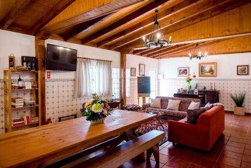 a living room with a wooden table and a couch at Vale do Grou Natura in Óbidos