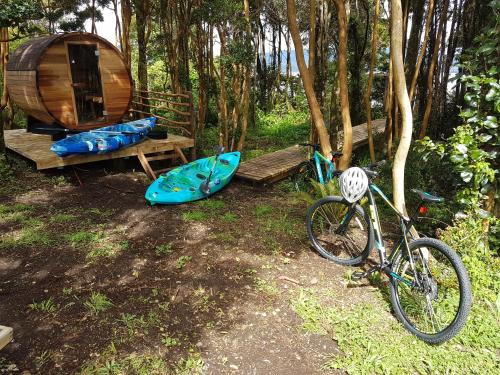 a bike parked next to a wooden bench and a tent at Cabañas Torre Huillinco in Huillinco