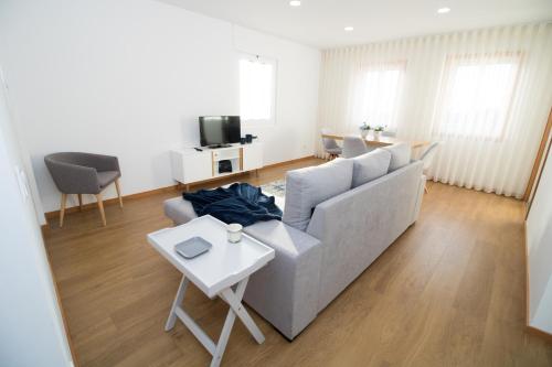 a living room with a couch and a table at Casas do Paço - Philosophy Apartments in Braga