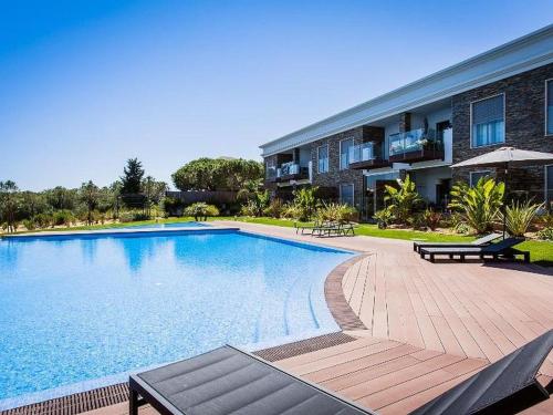 a large swimming pool in front of a building at Luxurious T2 apartment, Olhos Dagua in Albufeira