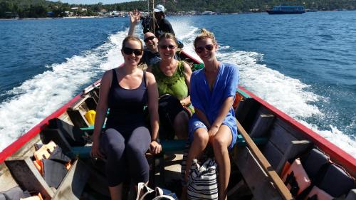 a group of people sitting in a boat on the water at Woodlawn Villas Resort in Koh Tao