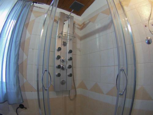 a shower in a bathroom with a shower curtain at Country house "L'isola che non c'è" in Ancona