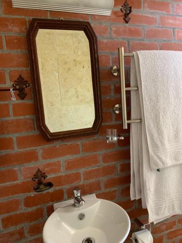 a bathroom with a mirror and a sink at Sapphire Studio in Noordhoek