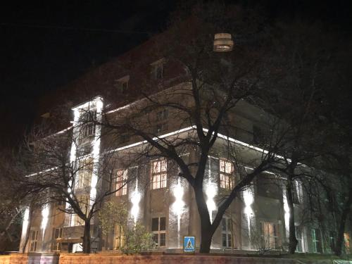 a large building with lights on it at night at Апарт-отель "ГАЛАГОВЪ" in Uzhhorod