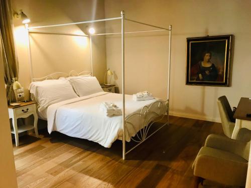 a bedroom with a bed with a metal canopy at Assaporarte in Florence