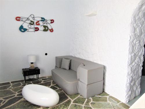 a living room with a couch and a chair at AMO Folegandros in Karavostasi