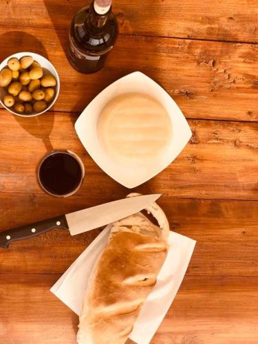 a table with a plate of bread and a bowl of nuts at Cabañas Morita Mia in San Rafael