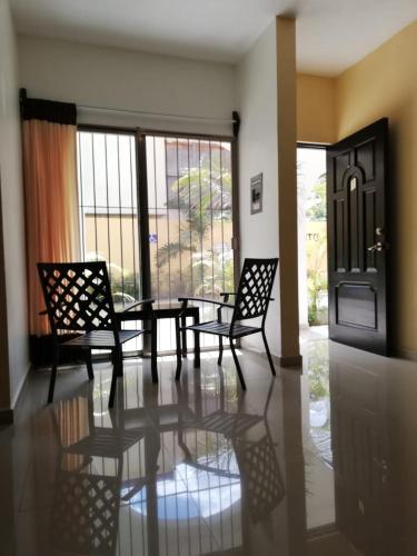 a dining room with a table and two chairs at Departamentos X`Kanlol in Izamal