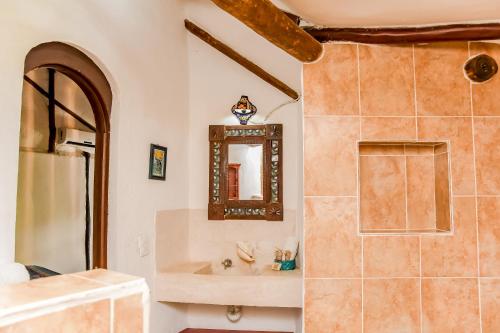 a bathroom with a mirror and a sink at Zomay Beachfront Holbox in Holbox Island