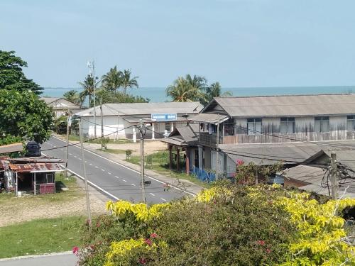 an empty street in a village with houses at Rumah Hentian Ayah in Kuala Besut