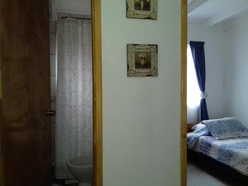 a bathroom with a door leading to a bedroom at Departamento a minutos del centro in Puerto Montt