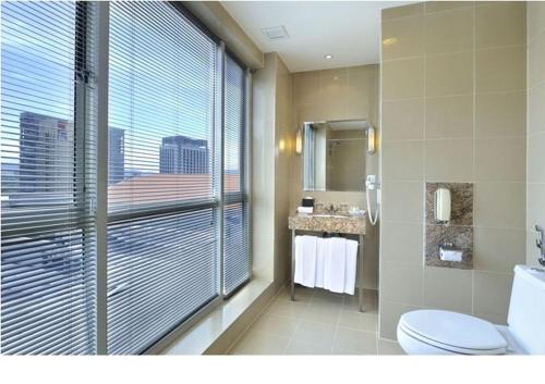 a bathroom with a toilet, sink and tub at Hotel Capitol Kuala Lumpur in Kuala Lumpur