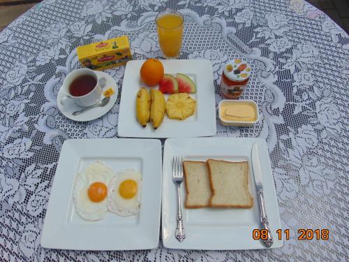 a table with plates of breakfast food and a cup of coffee at SRI LANKAN VILLA in Galle