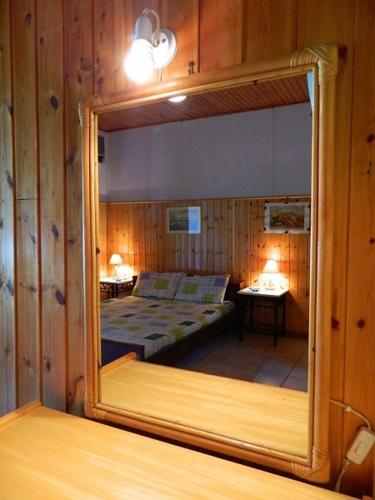 a mirror reflecting a bedroom with a bed in a room at Corfu Dream Village in Ipsos