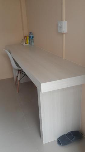 a white desk in a corner of a room at Patchy & PPraw Family in Ubon Ratchathani